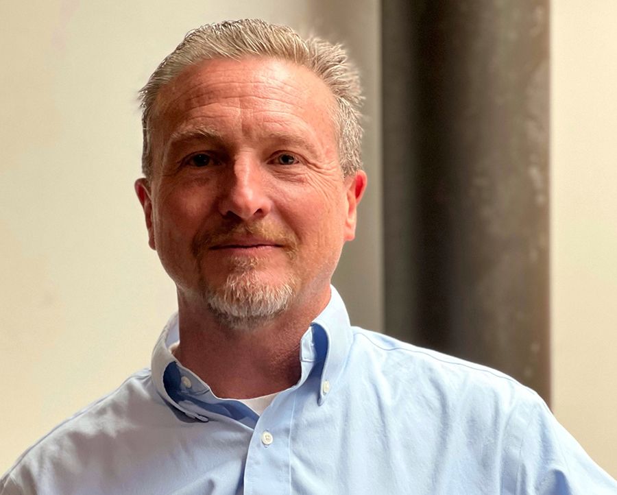 Headshot of Lou Cripps showing a man with a beard smiling into the camera