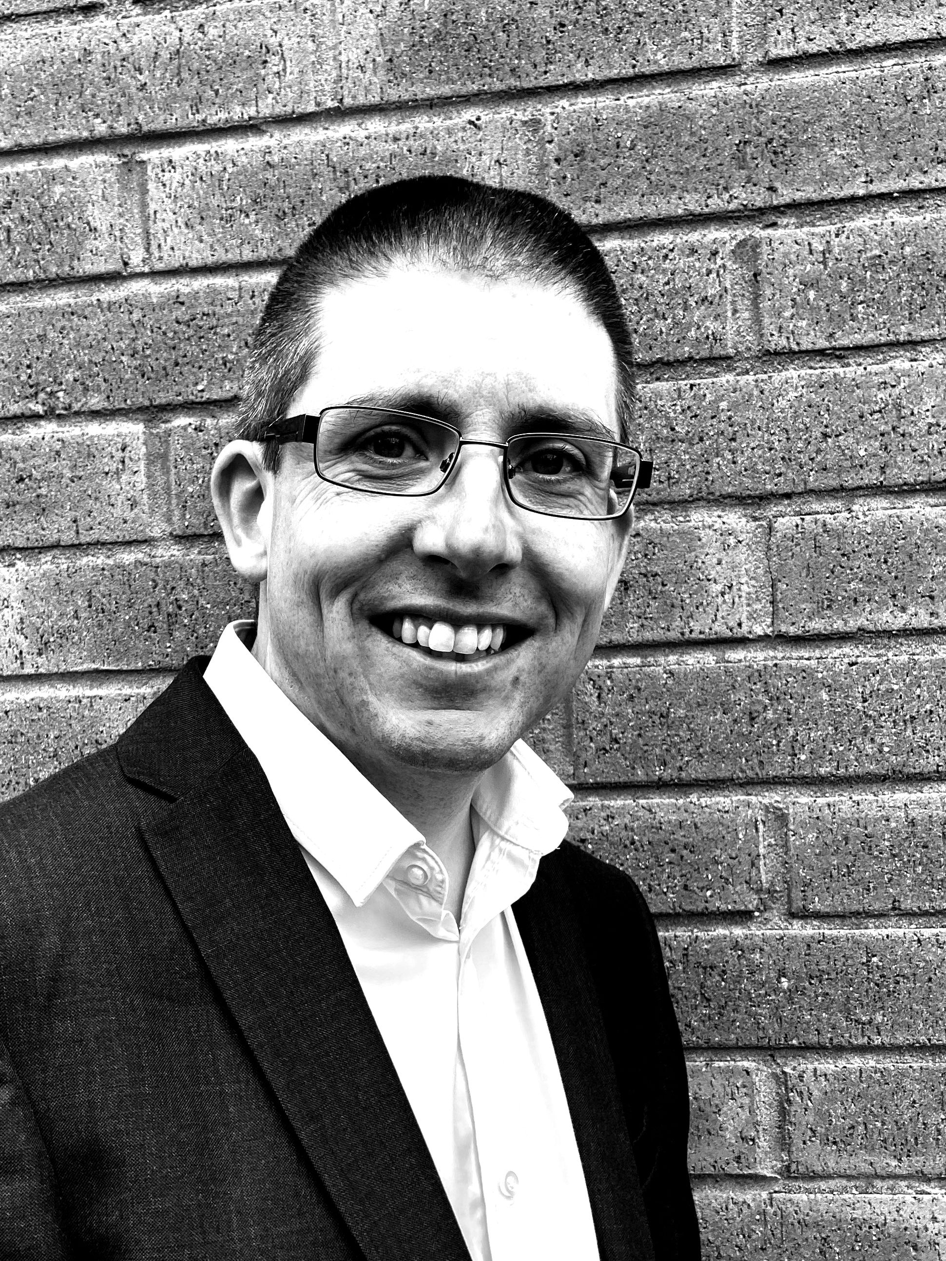 Headshot of David Tunley, smiling into camera