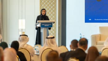 Woman at a platform, addressing a conference