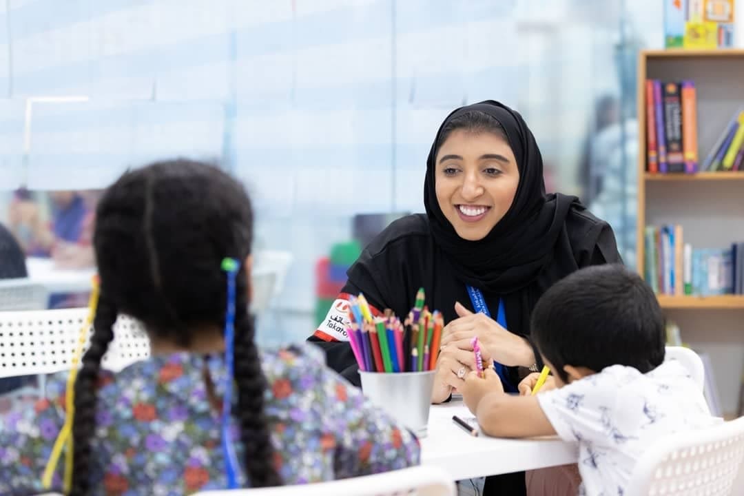 Woman and children doing an art activity
