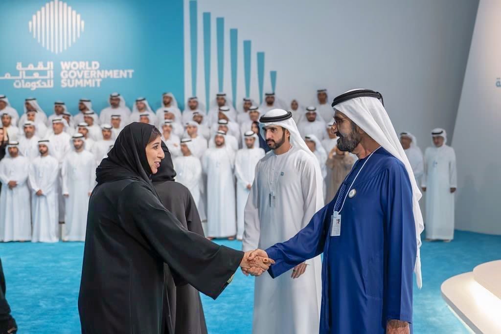 A woman shaking hands with a man in a conference location