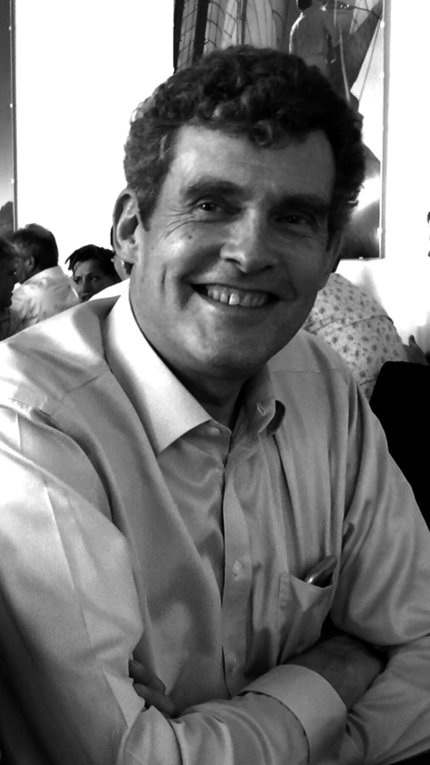 Head and shoulders image of a man looking relaxed and smiling into the camera