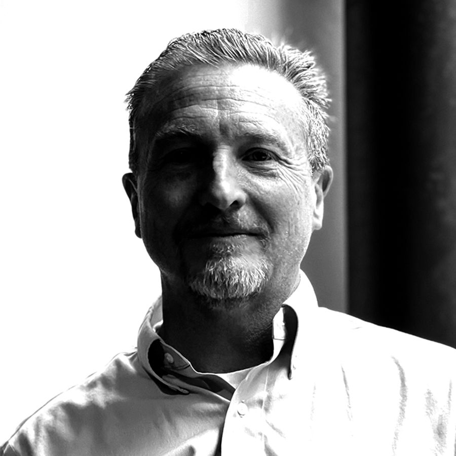 Head and shoulders image of a man in a suit facing into the camera