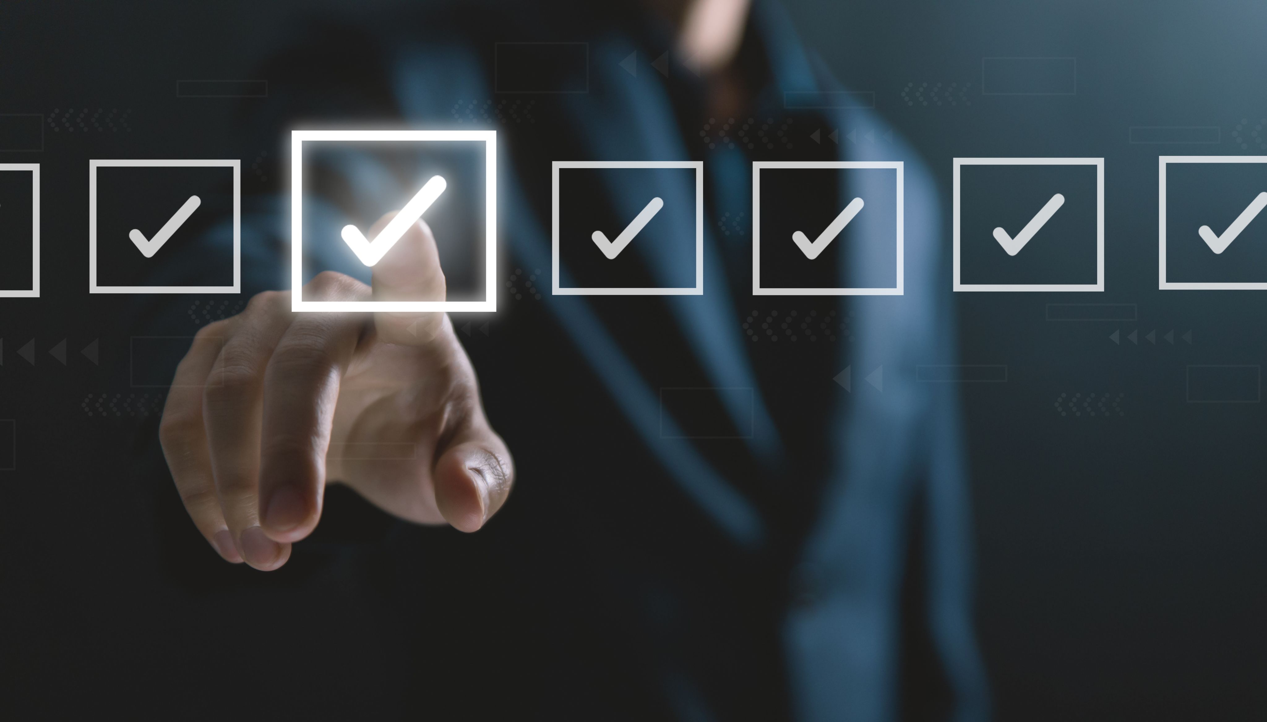 Image showing a screen with a line of tick boxes – we can see a person's hand is selecting one of them